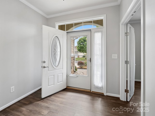 foyer entrance with baseboards, ornamental molding, and wood finished floors