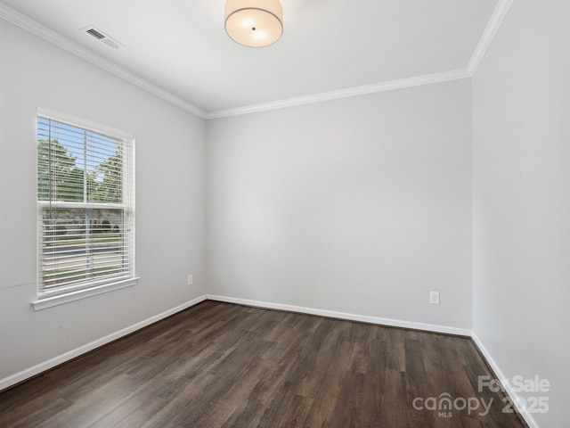 empty room with crown molding, baseboards, visible vents, and dark wood-style floors