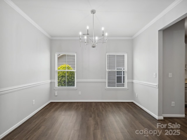 unfurnished dining area featuring baseboards, ornamental molding, wood finished floors, and a notable chandelier
