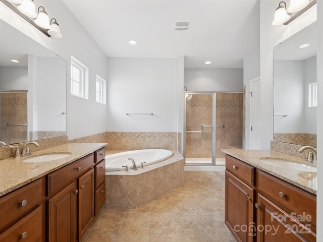bathroom with a sink, a bath, two vanities, and a shower stall
