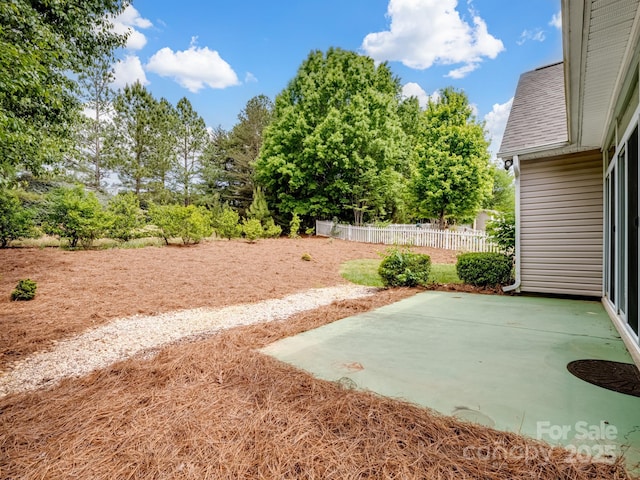 view of yard featuring fence and a patio area