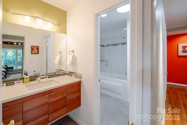 full bathroom with vanity, baseboards, and shower / tub combination
