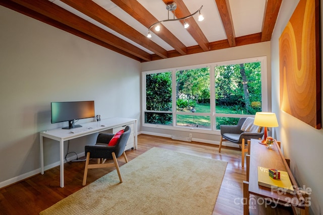 home office with baseboards, lofted ceiling with beams, and wood finished floors