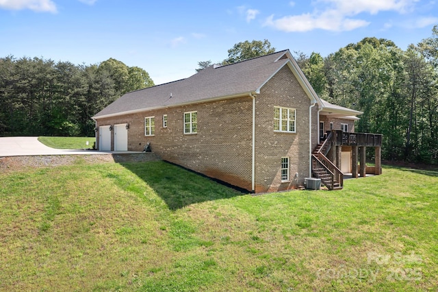 view of side of property featuring driveway, a garage, stairway, brick siding, and central air condition unit