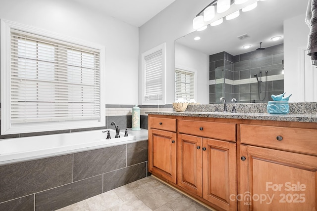 full bathroom featuring tile patterned flooring, vanity, a shower stall, visible vents, and a bath
