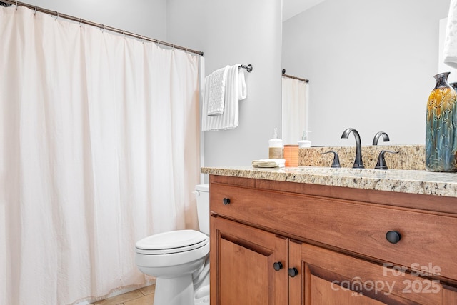 bathroom featuring tile patterned floors, vanity, and toilet