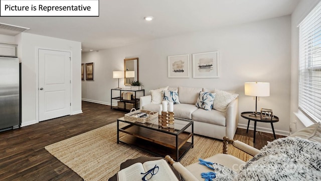 living area with baseboards, recessed lighting, and wood finished floors