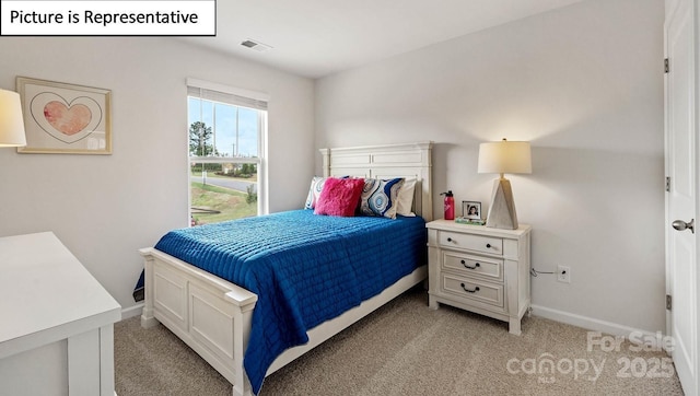 bedroom with visible vents, baseboards, and light carpet