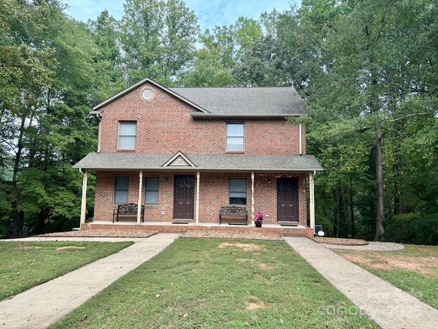 116 Fairview St, Shelby, NC 28152 - view of front facade featuring a shingled roof, a front yard, brick siding, and a porch