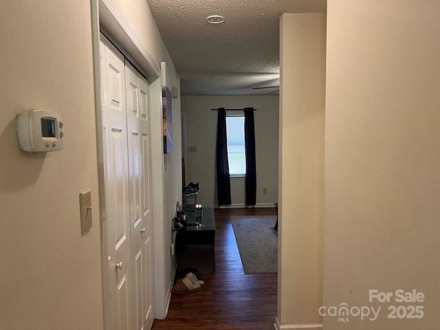 116 Fairview St, Shelby, NC 28152 - corridor featuring a textured ceiling, dark wood-type flooring, and baseboards