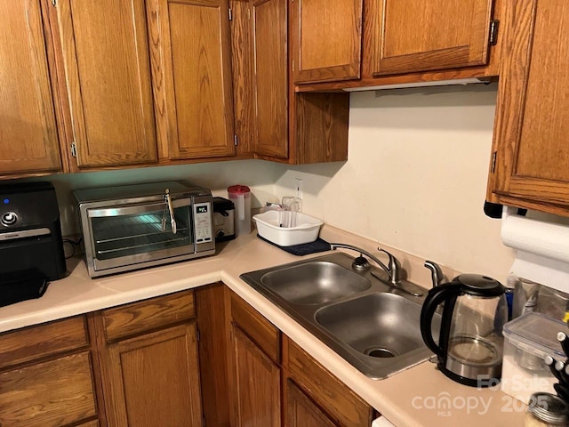 116 Fairview St, Shelby, NC 28152 - kitchen featuring a sink, light countertops, and brown cabinetry