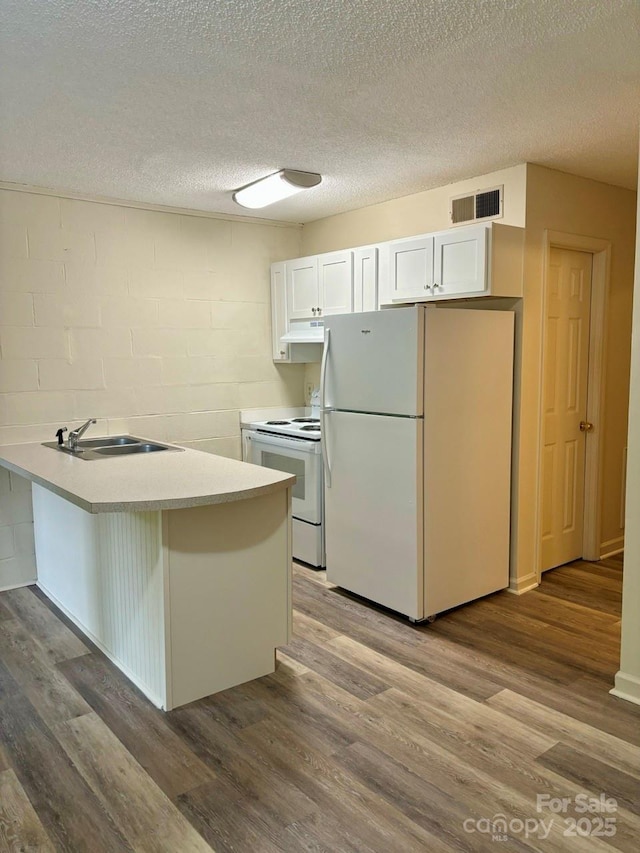 116 Fairview St, Shelby, NC 28152 - kitchen with white appliances, a sink, a peninsula, white cabinetry, and a textured ceiling