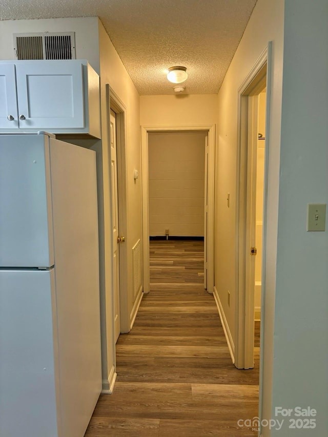 116 Fairview St, Shelby, NC 28152 - hall with wood finished floors, a textured ceiling, and baseboards