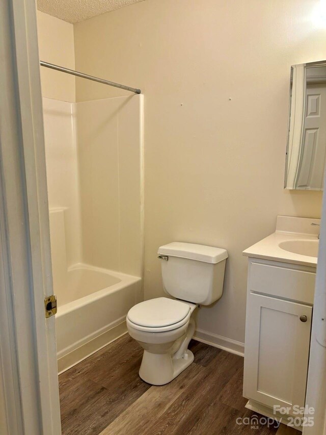 116 Fairview St, Shelby, NC 28152 - bathroom with wood finished floors, toilet, vanity, shower / washtub combination, and baseboards