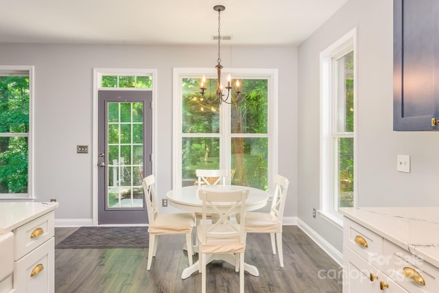 dining room featuring a chandelier, dark wood-style floors, and baseboards