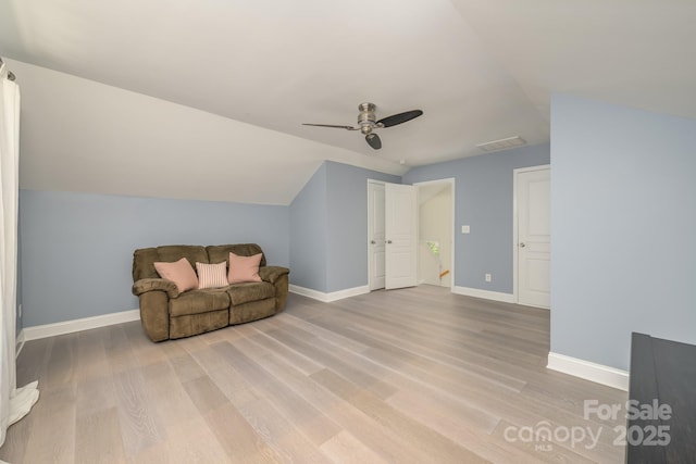 unfurnished room with lofted ceiling, light wood finished floors, baseboards, and ceiling fan