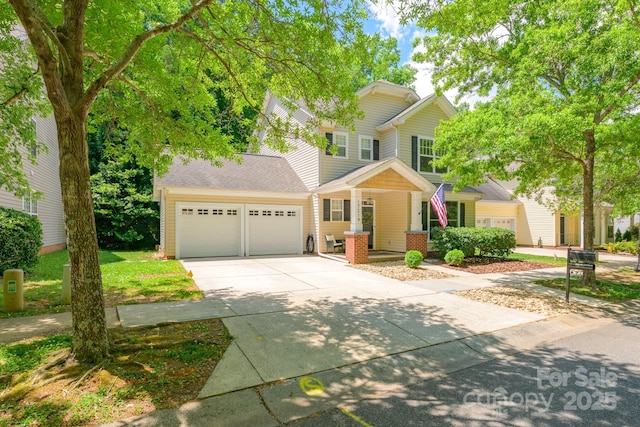 view of front of house featuring a garage, driveway, and covered porch