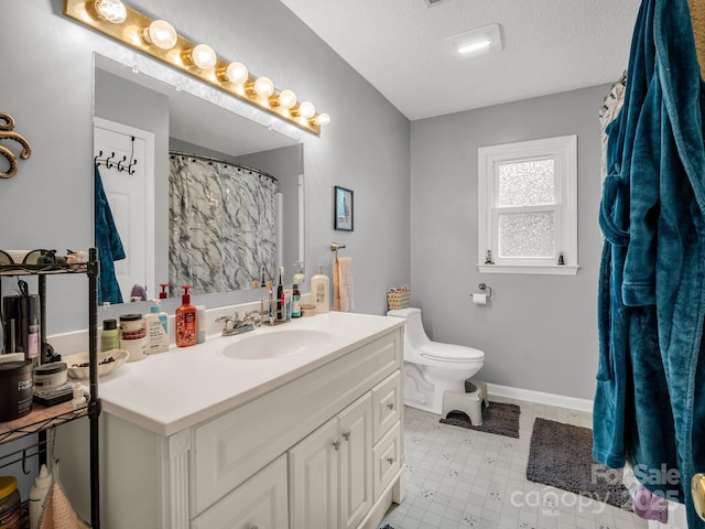 full bathroom featuring vanity, a textured ceiling, baseboards, and toilet