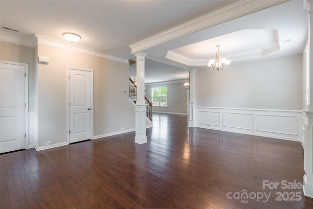 empty room with stairway, hardwood / wood-style flooring, a chandelier, and visible vents