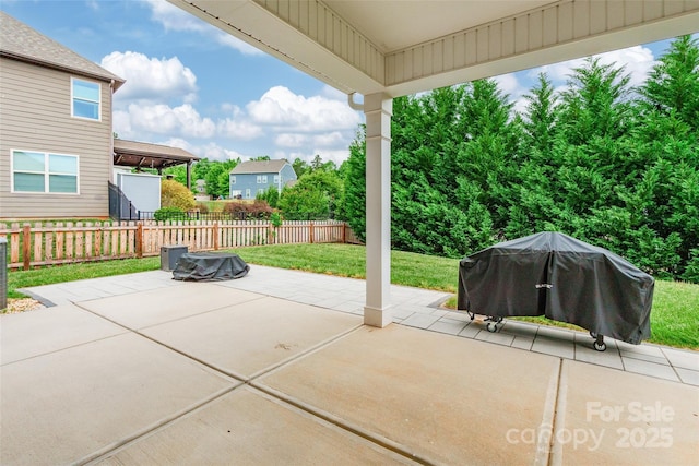 view of patio / terrace featuring fence and a grill