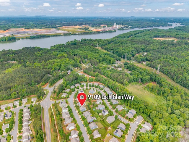 aerial view with a view of trees and a water view