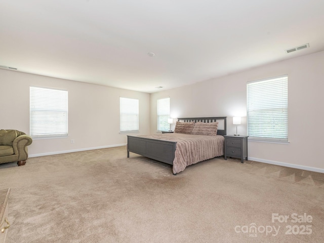 bedroom with light carpet, baseboards, and visible vents