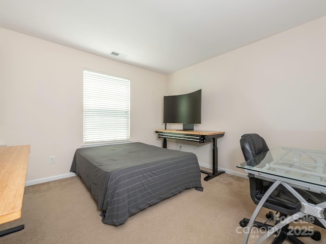 bedroom with baseboards, visible vents, and carpet