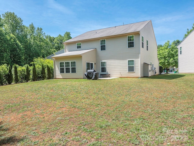 rear view of property with a lawn