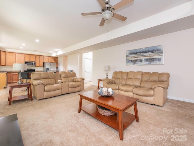 living room with ceiling fan, light carpet, baseboards, and recessed lighting