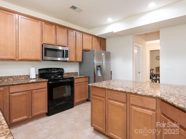 kitchen with recessed lighting, light stone counters, visible vents, and appliances with stainless steel finishes