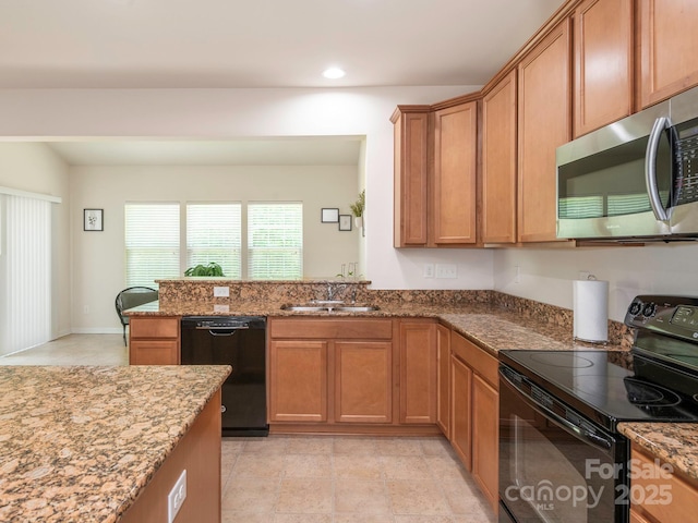 kitchen featuring a sink, brown cabinets, black appliances, recessed lighting, and light stone countertops