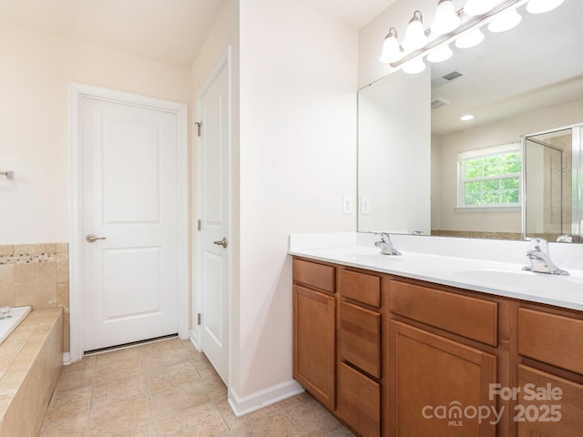 bathroom with double vanity, a garden tub, a stall shower, a sink, and visible vents