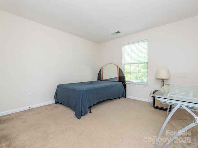 carpeted bedroom with visible vents and baseboards