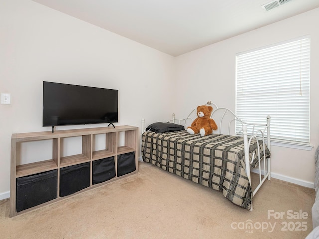bedroom with carpet, visible vents, and baseboards
