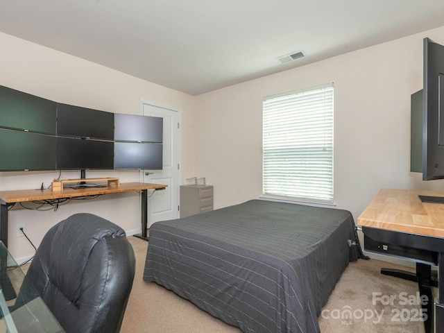 bedroom with visible vents and light colored carpet
