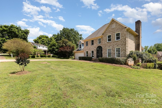 109 Arabian Ln, Salisbury, NC 28147 - view of front facade with a chimney, concrete driveway, a front yard, and brick siding