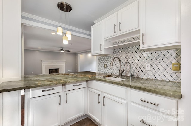 109 Arabian Ln, Salisbury, NC 28147 - kitchen with a sink, ceiling fan, decorative backsplash, white cabinetry, and dark stone countertops