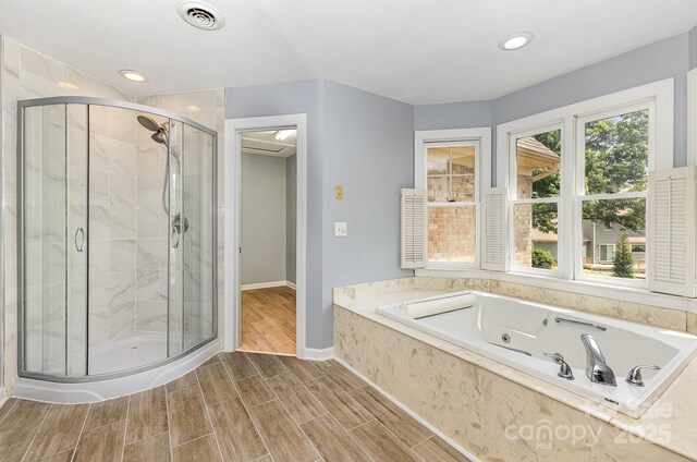 109 Arabian Ln, Salisbury, NC 28147 - full bathroom with a stall shower, a jetted tub, wood tiled floors, baseboards, and recessed lighting