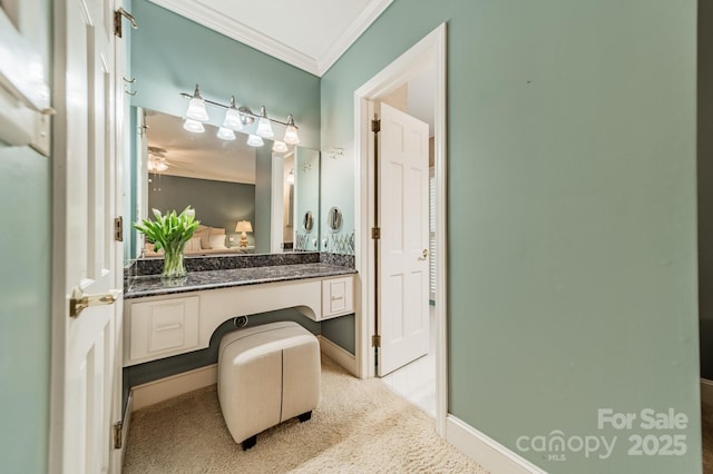 bathroom featuring ornamental molding, baseboards, vanity, and a ceiling fan
