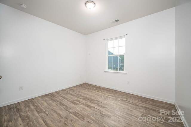 150 Falls Cove Dr, Troutman, NC 28166 - spare room with baseboards, visible vents, and wood finished floors