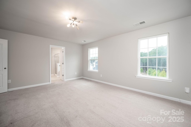 150 Falls Cove Dr, Troutman, NC 28166 - spare room featuring baseboards, light colored carpet, and visible vents