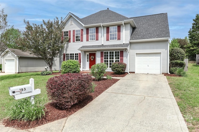 view of front facade featuring concrete driveway, a front yard, a shingled roof, and a garage