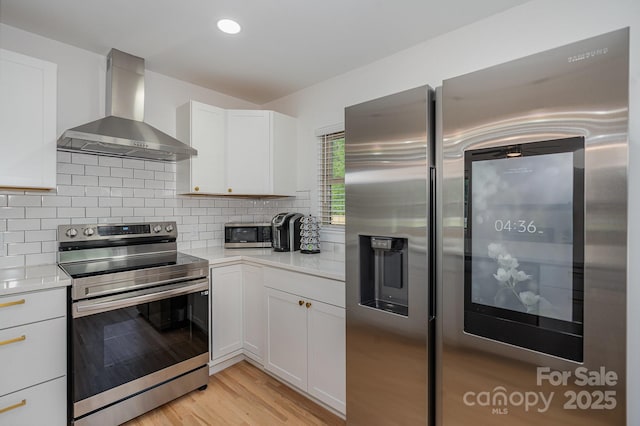 6301 Vernedale Rd, Charlotte, NC 28212 - kitchen with stainless steel appliances, wall chimney range hood, light countertops, light wood-type flooring, and recessed lighting