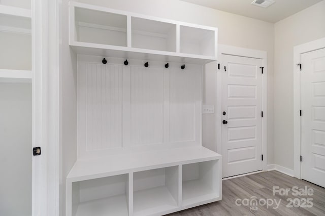 mudroom featuring visible vents, light wood-type flooring, and baseboards