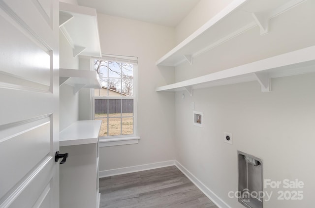 laundry room featuring hookup for a washing machine, wood finished floors, laundry area, hookup for an electric dryer, and baseboards