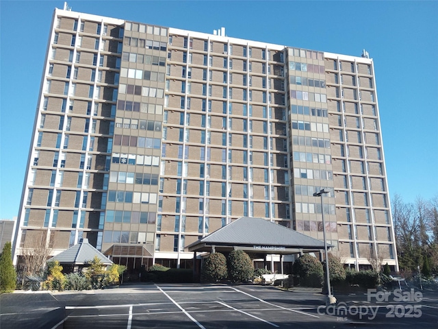 1101 N Elm St Unit 603, Greensboro, NC 27401 - view of building exterior with uncovered parking