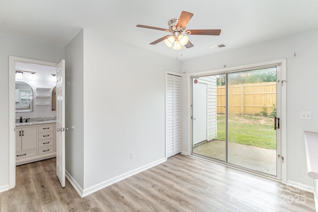 unfurnished bedroom featuring visible vents, light wood-style floors, baseboards, and access to exterior