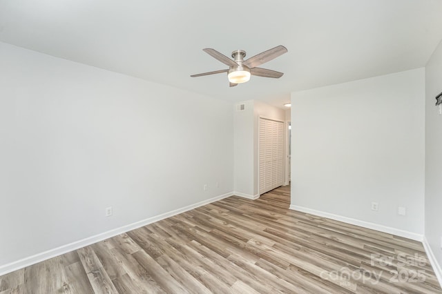 unfurnished room with a ceiling fan, baseboards, visible vents, and light wood-style floors