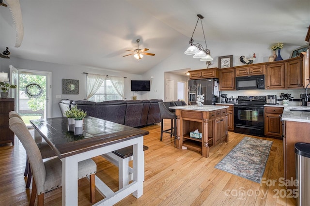 6084 Little River Ct, Granite Falls, NC 28630 - kitchen with black appliances, open shelves, brown cabinetry, lofted ceiling, and a kitchen island