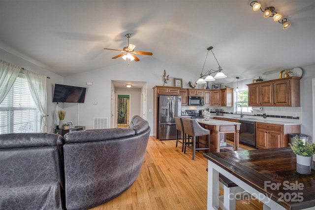 6084 Little River Ct, Granite Falls, NC 28630 - living area with a ceiling fan, light wood-type flooring, and vaulted ceiling